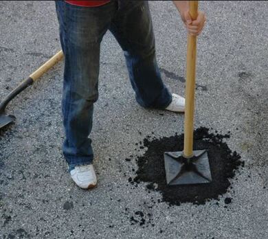filling in pot holes in parking lot before resurfacing