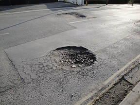 a roadway pothole that needs repaired